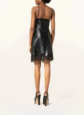 Black leather dress with lace details on a white background